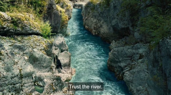 A shot of the river with the text "Trust the river"