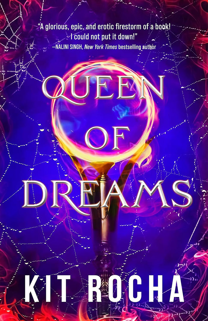 The cover of Queen of Dreams, which has a glowing round globe topping a scepter, on a blue and pink smoky background criss-crossed with silver spider webs and flames around the edges.